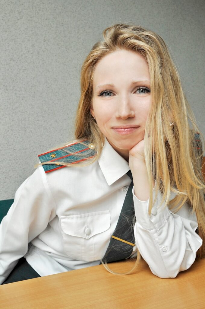 woman in white blazer smiling