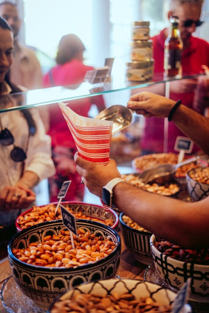 A group of people standing around a table filled with food