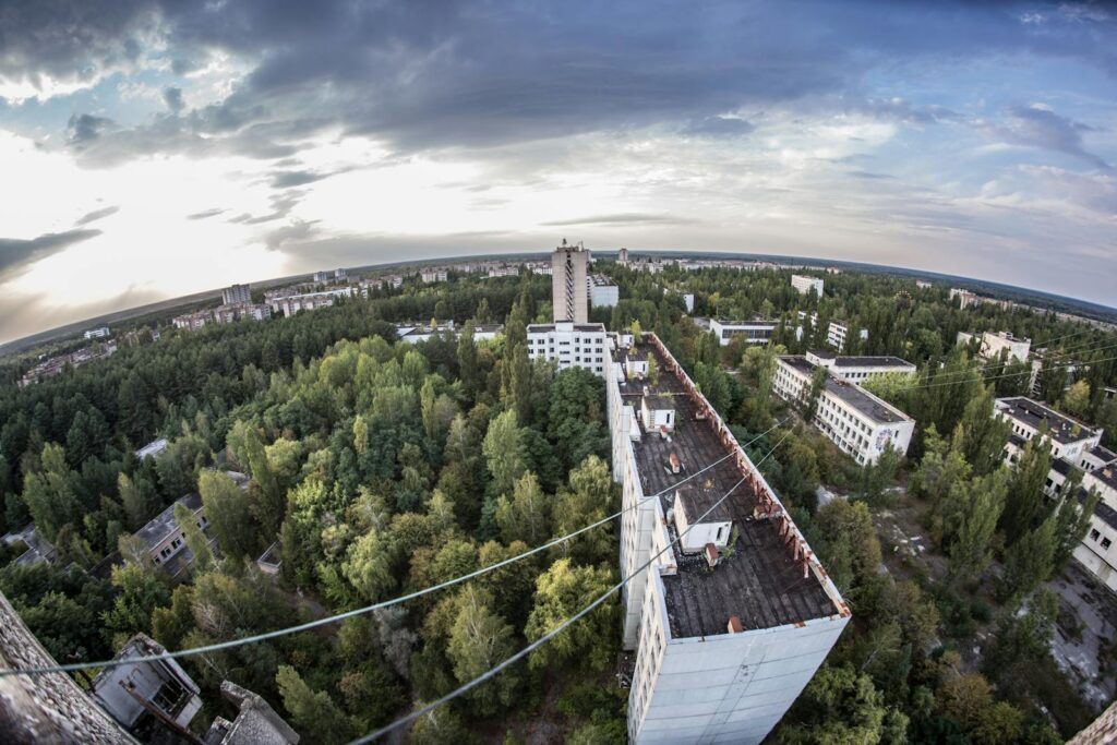 Aerial view of Chernobyl cityscape showing abandoned buildings and overgrown forests.
