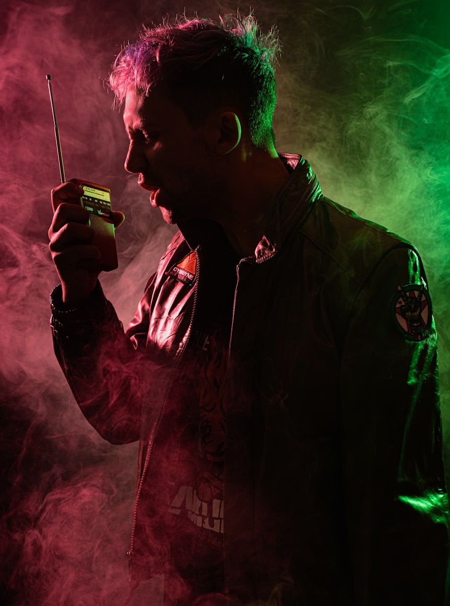 a man in a black jacket holding a cell phone